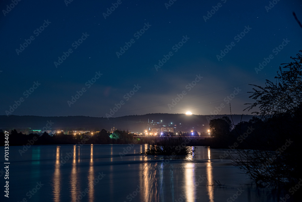 View of the city at night. Urban landscape. City by the river.