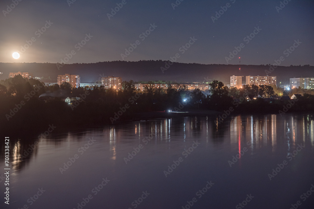 View of the city at night. Urban landscape. City by the river.