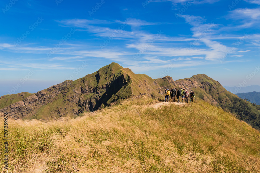 Group of hiking or hiker people stand in mountains and looking the target to go mountain peak at Khao Chang Phuak in Thong Phum National Park, Thailand. Group of hiking or hiker people stand in mountains and looking the target to go mountain peak at Khao Chang Phuak in Thong Phum National Park, Thailand.