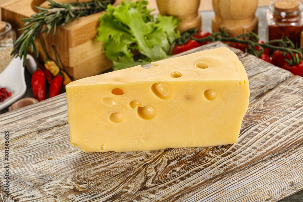 Swiss Maasdam cheese triangle over board Swiss Maasdam cheese triangle over board