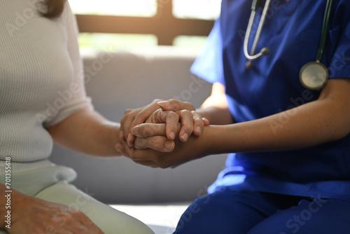 Cropped shot of caring nurse holding senior woman hands for hope and supporting. Elderly healthcare concept.