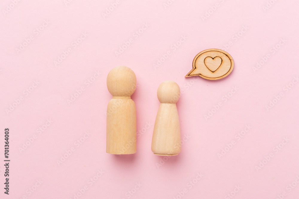 Wooden couple in love on color background, top view. Creative valentine's day composition Wooden couple in love on color background, top view. Creative valentine's day composition