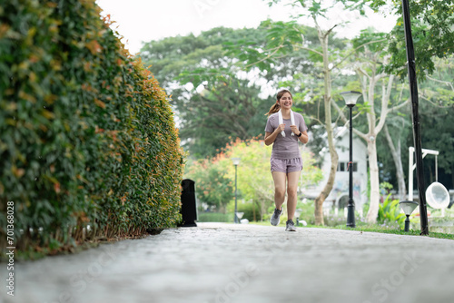 Women runner wearing sport cloths jogging in morning at park. Active morning