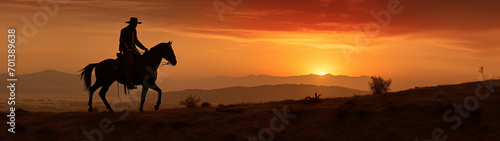 Panorama view of cowboy riding a horse with sunset background, only silhouette visible. Generative AI © Nipawan