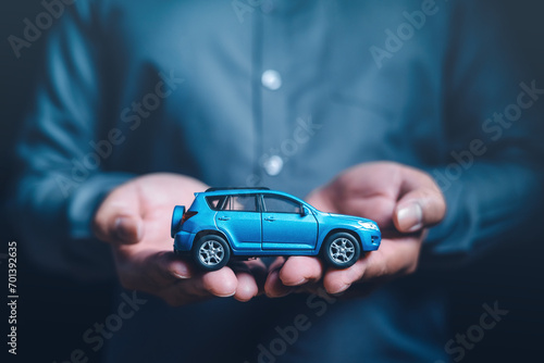 finance, investment, save, wealth, bank, banking, growth, asset, car, insert. closeup image of a hands and hold a blue suv car model asset to protect, financial, money, refinance, and car insurance.