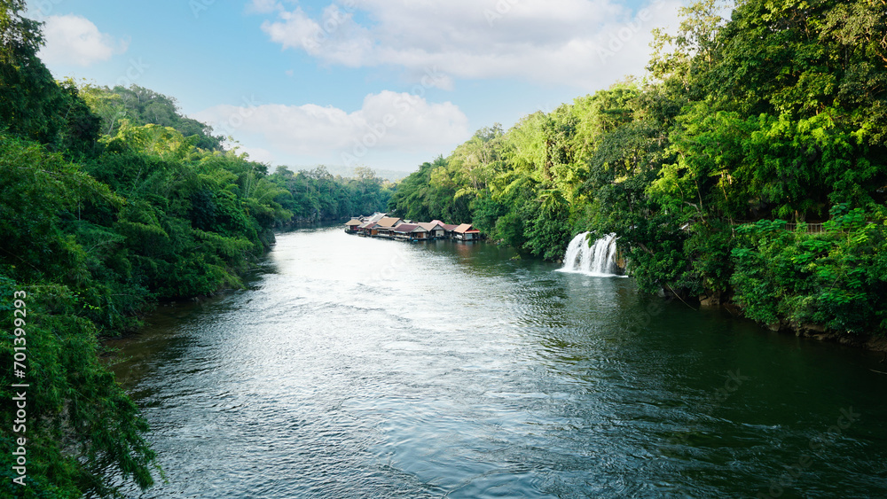 Rafts at the Kwai Noi river and Sai Yok Yai waterfalls in Sai Yok national park view in Kanchanaburi Province,Thailand Rafts at the Kwai Noi river and Sai Yok Yai waterfalls in Sai Yok national park view in Kanchanaburi Province,Thailand