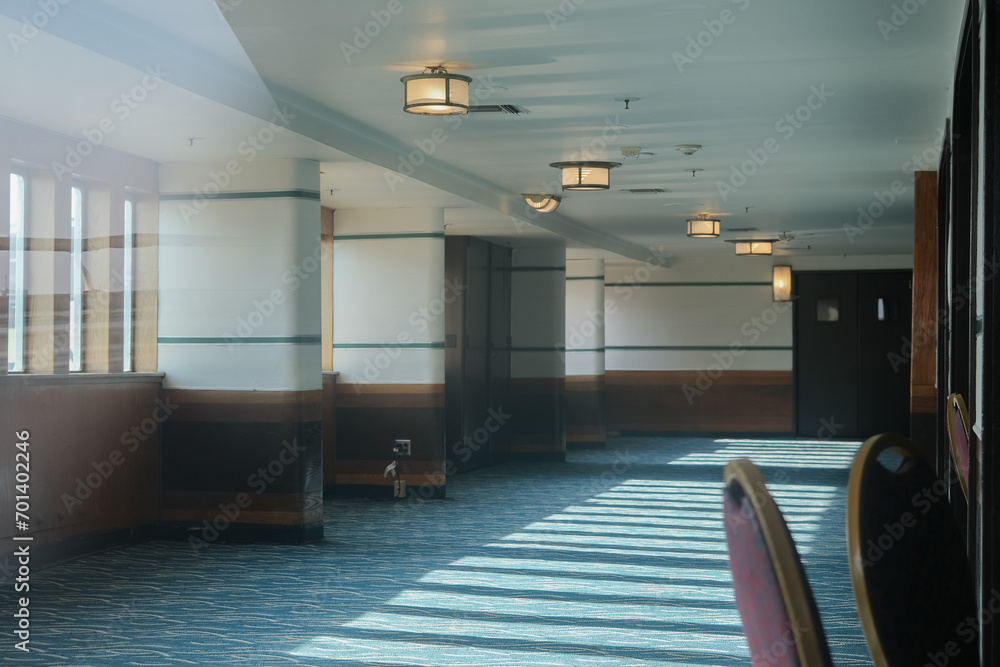 Opulent Art Deco interior design inside ballroom lounge bar atrium hall foyer of first class on legendary ocean liner cruiseship cruise ship with wood, chandeliers and furniture