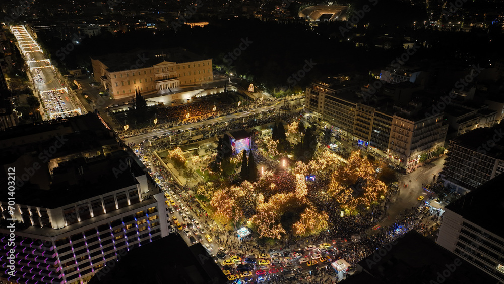 Obraz premium Aerial drone night shot of illuminated iconic Syntagma square at new year's eve celebration with fireworks welcoming 2024, Athens, Attica, Greece