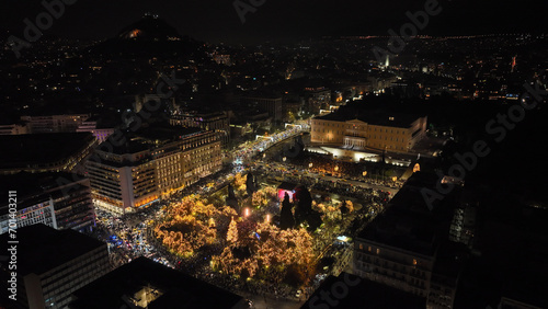 Aerial drone night shot of illuminated iconic Syntagma square at new year's eve celebration with fireworks welcoming 2024, Athens, Attica, Greece