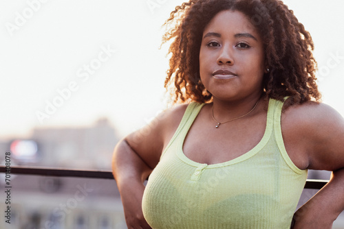 Close-up of portrait of young curvy attractive African. Charming dark girl in yellow top