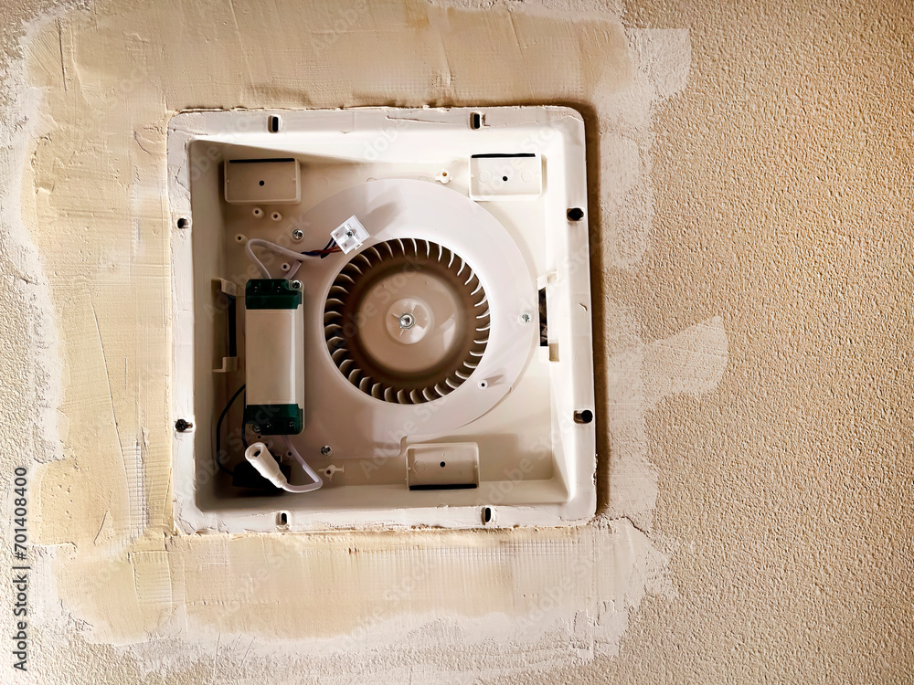 New ceiling fan duct being installed in bathroom ceiling with sheetrock