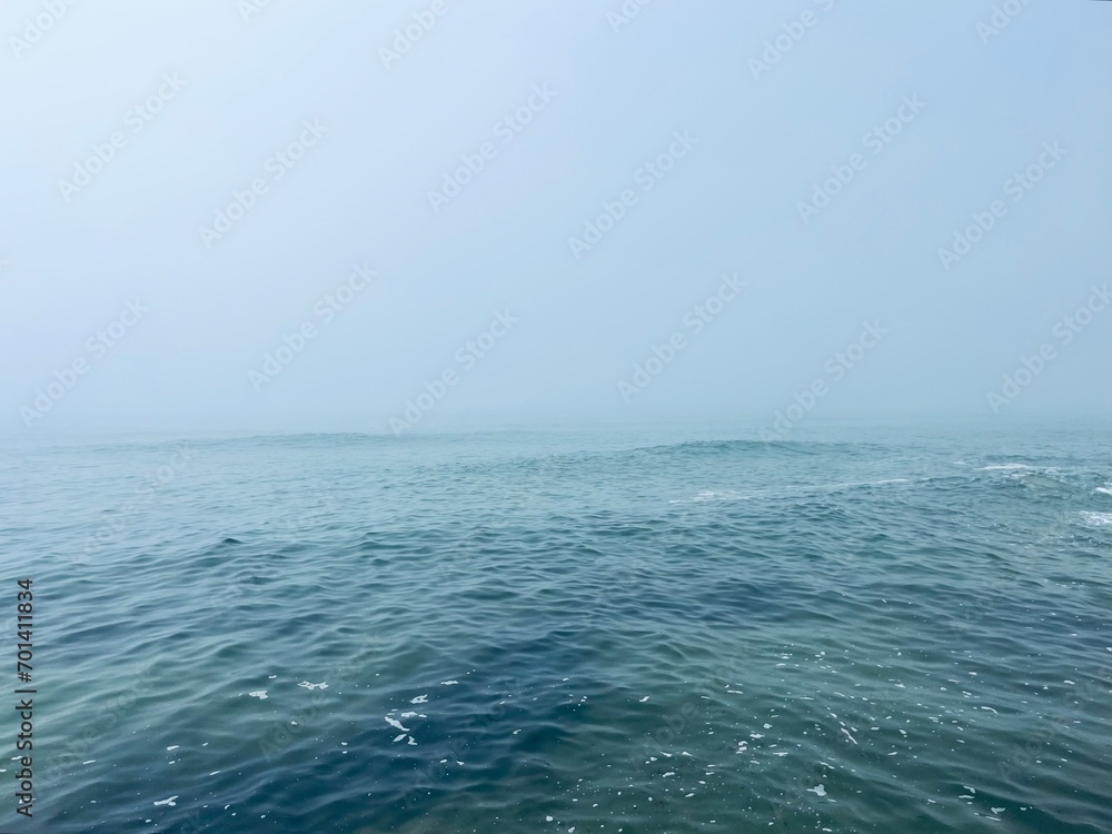 Fototapeta premium Foggy sea horizon, mist at the sea, mysterious seascape 