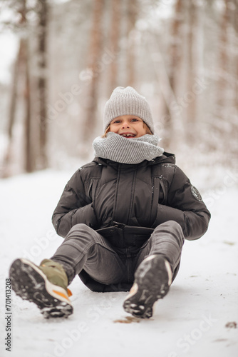 Portrait of a boy in a snowy forest