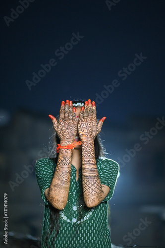 A Beautiful artwork henna on the hand of an Indian bride with herbal heena in wet condition 