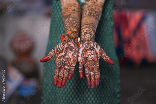A Beautiful artwork henna  on the hand of an Indian bride with herbal heena in wet condition
 photo