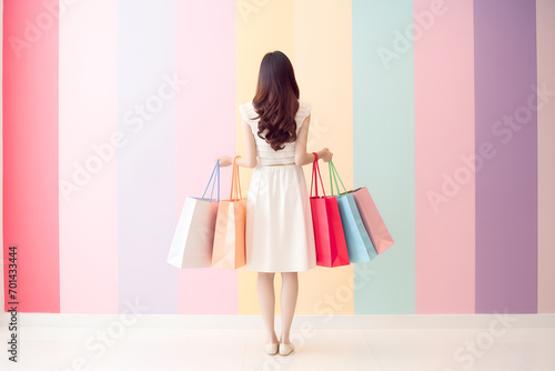 Trendy beautiful woman carrying bags and going shopping