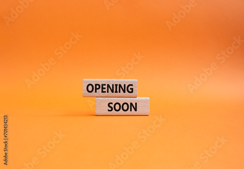 Opening soon symbol. Concept word Opening soon on wooden blocks. Beautiful orange background. Business and Opening soon concept. Copy space photo