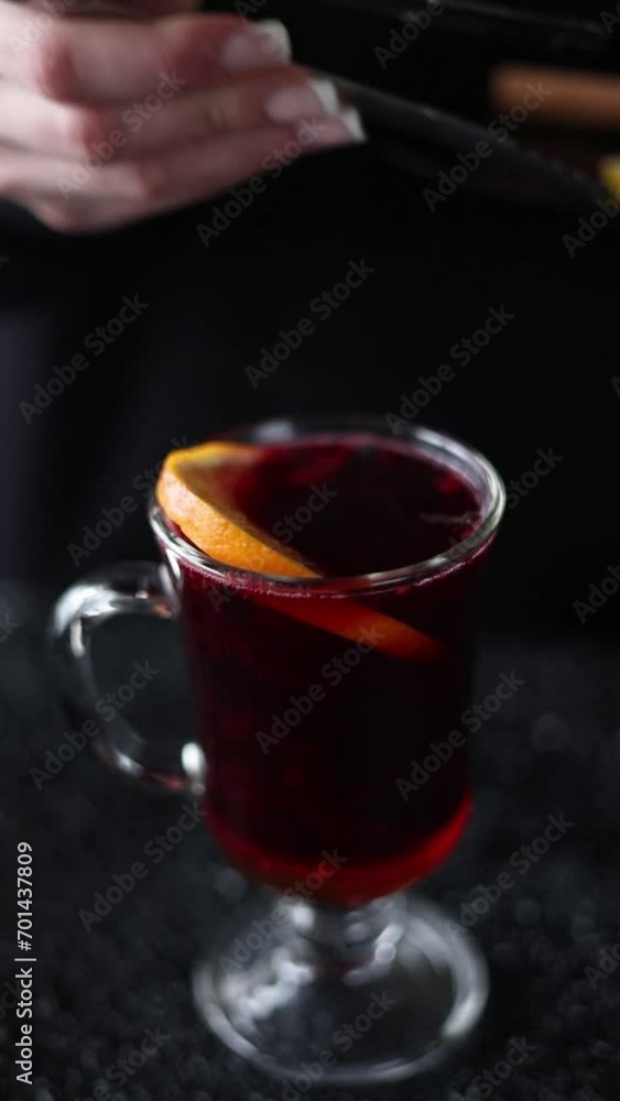 A bartender prepares mulled wine. Close-up A bartender prepares mulled wine. Close-up