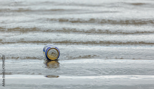 trash floating on ocean beach