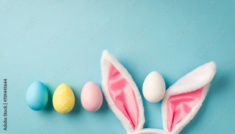 Happy Easter composition with vibrant decorated eggs and bunny ears on blue background. Happy Easter composition with vibrant decorated eggs and bunny ears on blue background.
