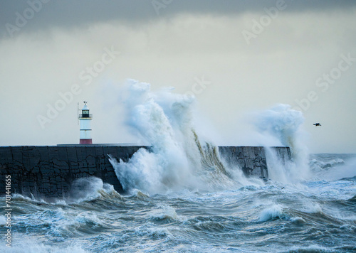 Fototapeta Naklejka Na Ścianę i Meble -  Lighthouse, Breakwater and Crashing Storm Waves at Newhaven