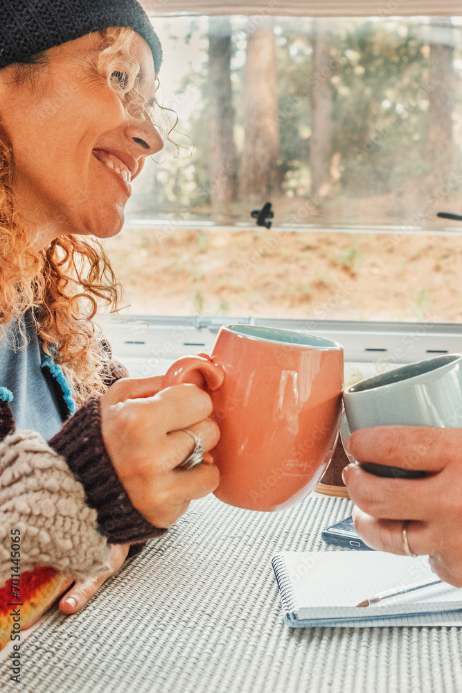 Couple enjoys the weekend aboard their camper. Happy man together with his wife spending pleasant moments. Concept of freedom and free time Couple enjoys the weekend aboard their camper. Happy man together with his wife spending pleasant moments. Concept of freedom and free time