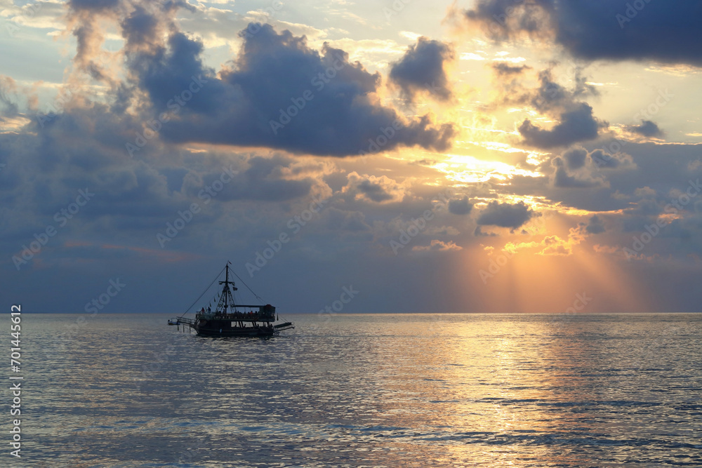 Sea sunset Ship. Blue Sea silhouette of the ship on the horizon. Sunset on the Ocean coast. Beautiful Seascape. Boat and sun reflection on the water. Beautiful sea at sunset. Ocean and sky background Sea sunset Ship. Blue Sea silhouette of the ship on the horizon. Sunset on the Ocean coast. Beautiful Seascape. Boat and sun reflection on the water. Beautiful sea at sunset. Ocean and sky background