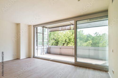 Panoramic large window to balcony from empty bedroom