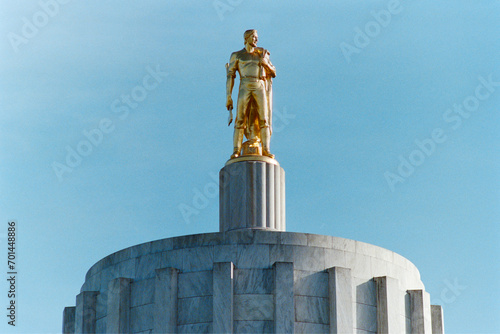 Grainy archival film photo of the Oregon State Capitol building rooftop pioneer statue.  Shot on slide film in May 1992.  The capitol building was completed in 1938.   photo