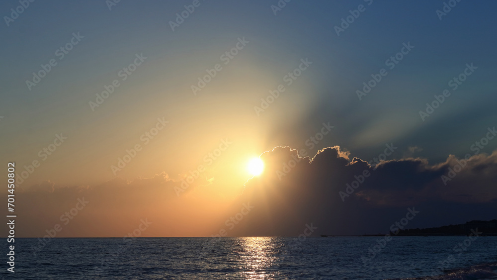 Bright beautiful Sunrise or Sunset at Sea. Bright sunset with a big sun under the Sea surface. Inspirational calm sea with sunset Sky. Ocean and Sky background. Colorful horizon over the water. Bright beautiful Sunrise or Sunset at Sea. Bright sunset with a big sun under the Sea surface. Inspirational calm sea with sunset Sky. Ocean and Sky background. Colorful horizon over the water.