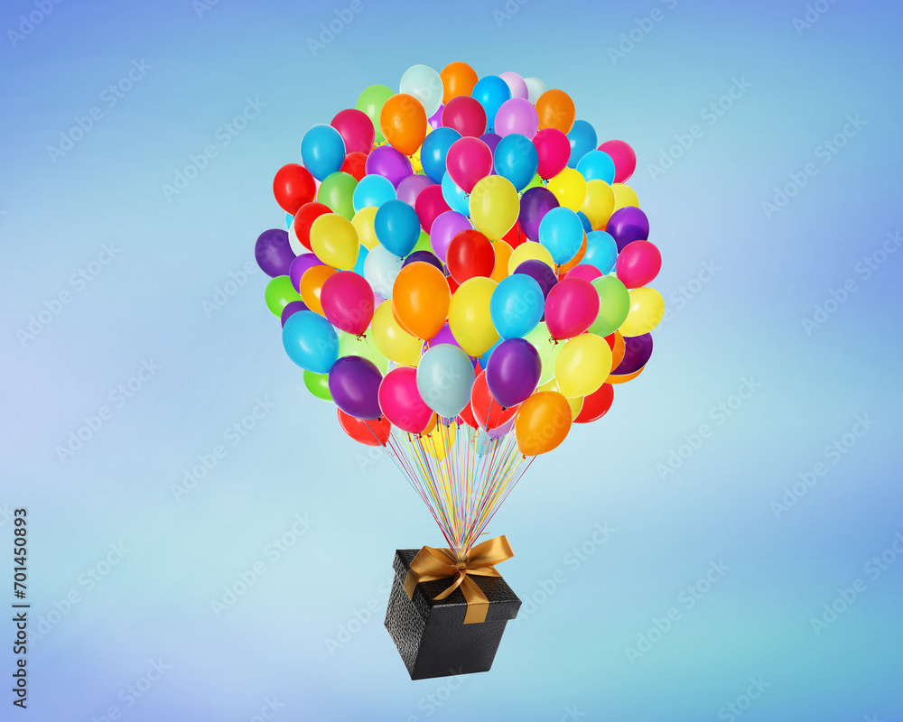 Naklejka premium Many balloons tied to gift box on bright background