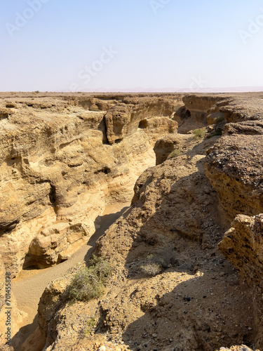 Sesriem, Namibia - August 24, 2022: A rugged Sesriem Canyon carved by natural forces, showcasing the geological layers and erosion patterns with a narrow riverbed.