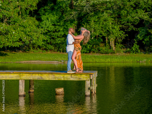 A Beautiful Young Interracial Couple Pose For Their Engagement Photographs Outdoors