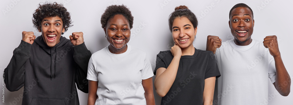 Horizontal shot of cheerful two men clench fists from triumph glad women smile positively dressed in casual clothes stand next to each other isolated on white background. People and positive emotions