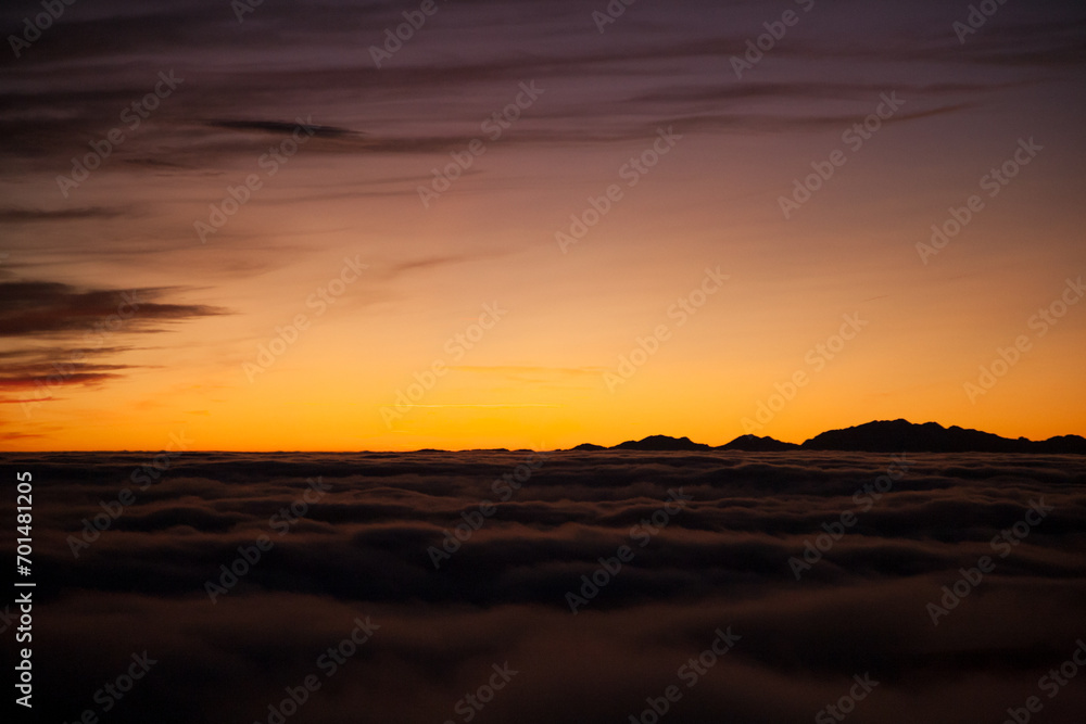 Spectacular sunset over a sea of clouds