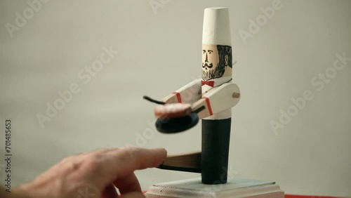 virtuoso chef tosses and turns pancakes in a frying pan, comic wooden push toy photo