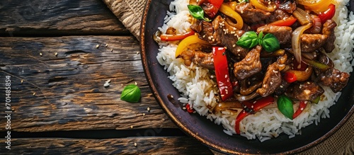 Stir fry Chinese pepper beef steak with onion red and green bell pepper rice in bowl. Creative Banner. Copyspace image