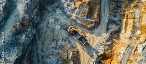 Srushing Plant and Belt conveyor in mining quarry Mining excavator loading sand in haul truck in opencast Stone crushing and bulk materials for construction Gold Open pit mining drone view