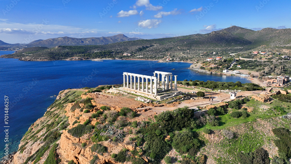 Aerial drone photo of iconic archaeological site of Cape Sounio and famous Temple of Poseidon built uphill overlooking Aegean sea, Attica, Greece