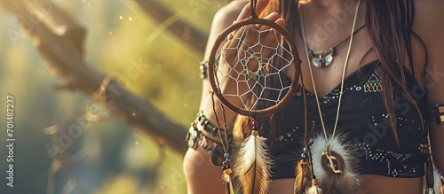 Pretty girl holding dream catcher in her hand. Creative Banner. Copyspace image #701487237