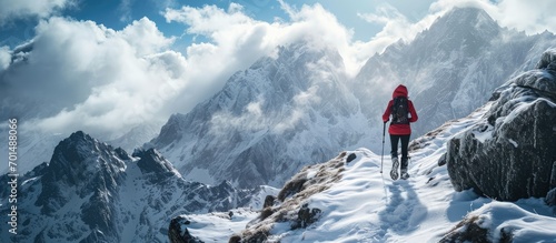 Woman trail runner cross country running up to winter snow mountain top. Creative Banner. Copyspace image