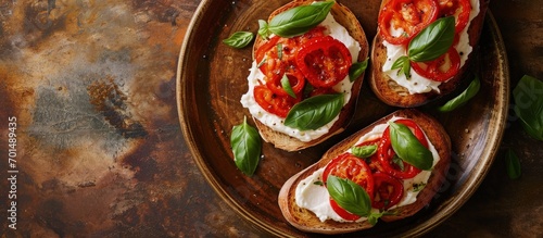 Open sandwiches with cream cheese baked sweet pepper and fresh basil on a brown plate Italian Cuisine Red pepper snacks Top view copy space. Creative Banner. Copyspace image