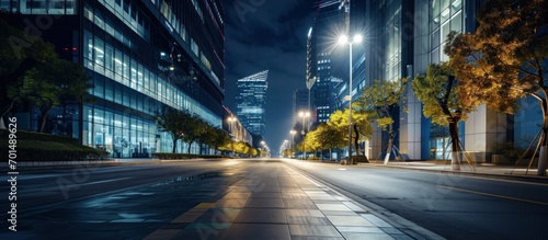 modern office buildings in hangzhou west lake square at night on view from empty street. Creative Banner. Copyspace image photo