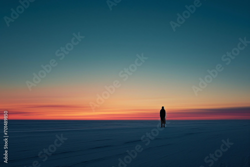 Solitary silhouette is framed against a horizon of twilight hues