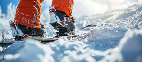 Snowboarder stands on slope backdrop Closeup legs and snowboard. Creative Banner. Copyspace image