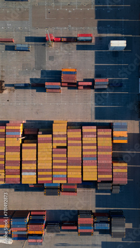 Aerial photography of containers transporting goods by ship. Logistics in the port. Colored containers. Rectangular shapes.