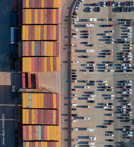 Aerial photography of containers transporting goods by ship. Logistics in the port. Colored containers. Rectangular shapes.