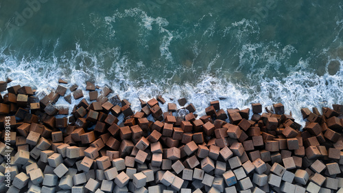 Breakwater seen from the drone. Waves breaking on the rocks of the pier. Concrete blocks in the sea. aerial photography. Ocean. photo