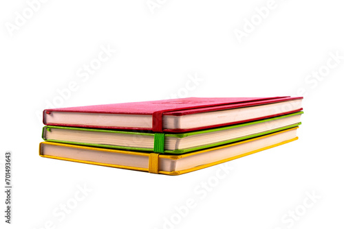 Closed paper notebooks in red, green and yellow color. Planner isolated on transparent png background. Design template of copybook with elastic band for mockup. 