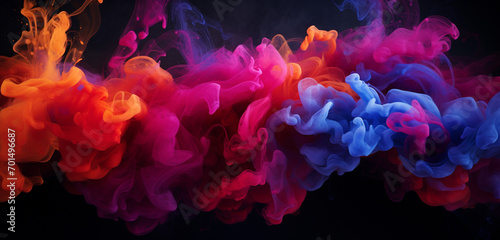 Cascading bursts of ruby and cobalt-colored smoke intertwining in a captivating and colorful dance against a dark backdrop.